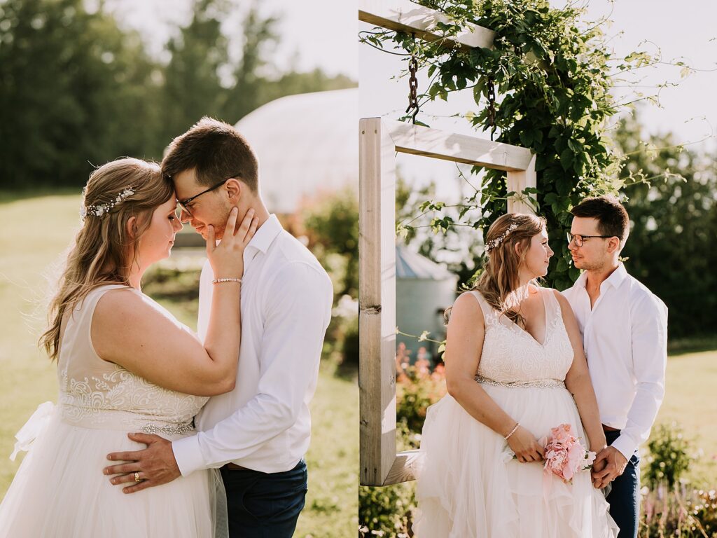 bride and groom standing in nature and snuggling close while posing for wedding photos. 