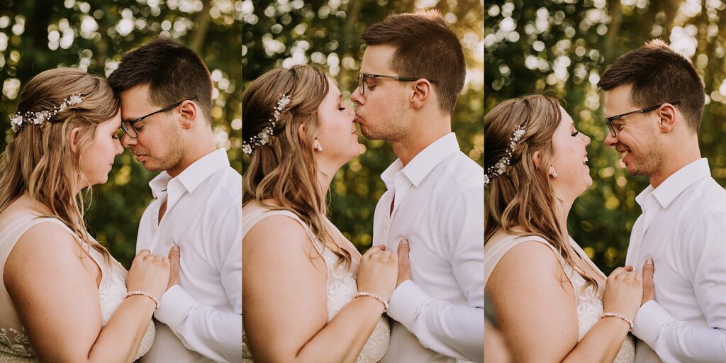 bride and groom standing in nature and snuggling close while posing for wedding photos.