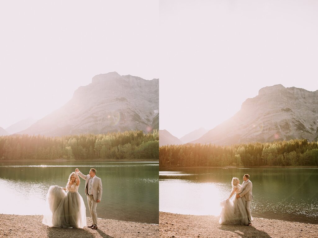 bride and groom snuggling romantically in front of a pond. The lighting is soft and there is a mountain range behind them