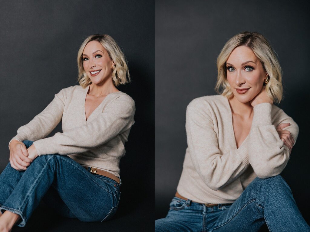 woman posing for professional portraits. She is in front of a black background. She is wearing a tan sweater and blue jeans. She looks happy and relaxed. 