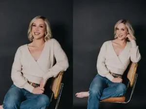 woman posing for professional portraits. She is in front of a black background. She is wearing a tan sweater and blue jeans. She looks happy and relaxed.